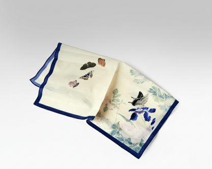 Two decorative napkins with butterfly and floral patterns on a white background