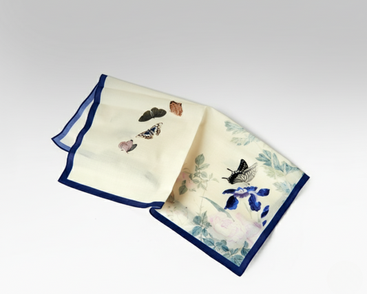 Two decorative napkins with butterfly and floral patterns on a white background