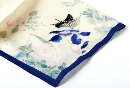 Floral and butterfly patterned fabric square on a white background